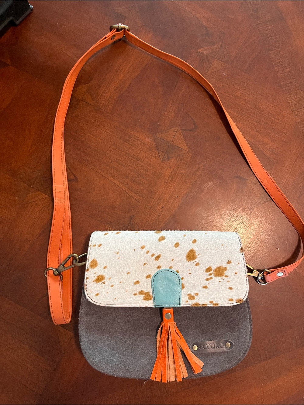 Spotted Cowhide Flap Crossbody Bag with Orange Strap and Tassel